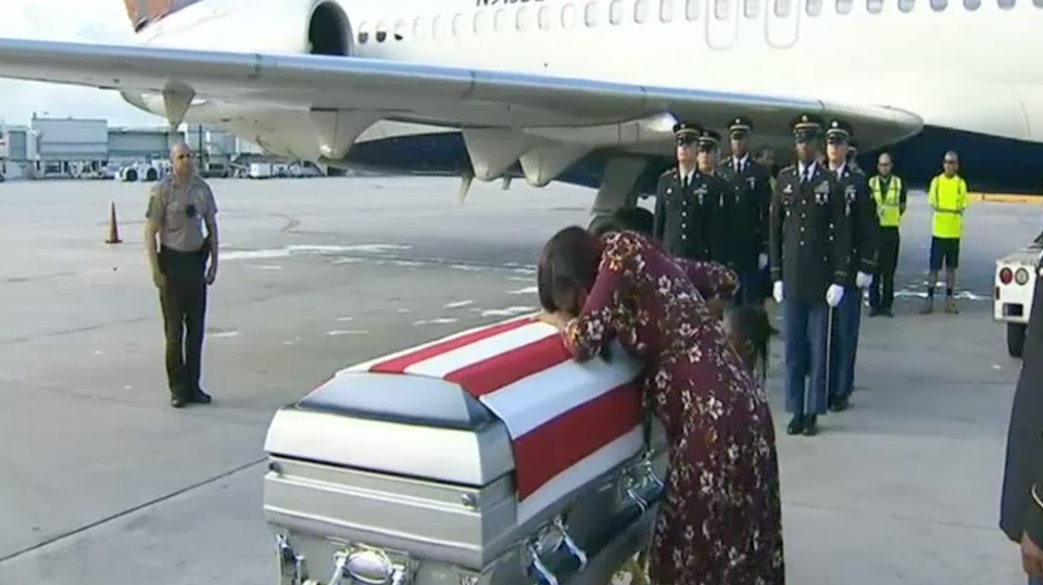Pregnant Myeshia Johnson sobs over the coffin of her husband as after he was brought back to the US