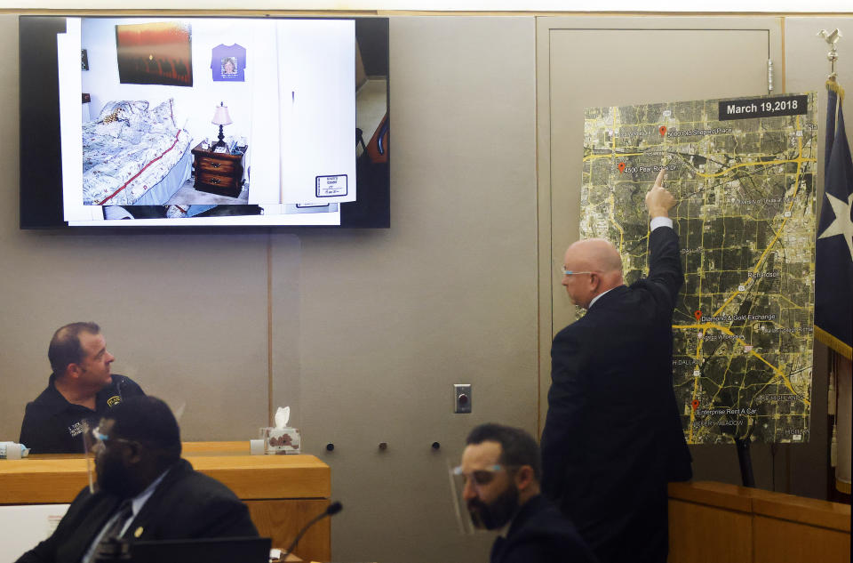 Lead prosecutor Glen Fitzmartin, right, points to a map where a victim who lived resided. He was questioning Plano firefighter Steven Tuck, left, during the murder trial of Billy Chemirmir at the Frank Crowley Courts Building in Dallas, Monday, Nov. 15, 2021. Chemirmir is charged with killing 18 older women in Dallas and its suburbs over a two-year span. (Tom Fox/The Dallas Morning News via AP, Pool)