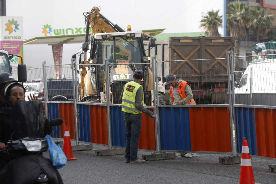 Workmen in Casablanca, Morocco, Tuesday, April 6, 2021. Moroccan authorities have announced the discovery of a new local variant of the coronavirus and extended an overnight curfew as infections rise again. (AP Photo/Abdeljalil Bounhar)