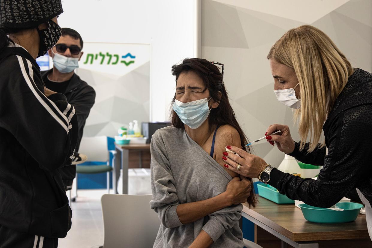 A woman receives a Pfizer-BioNTech COVID-19 vaccine at a medical center in Dimona, Israel on Sunday.