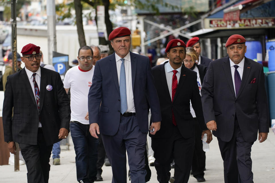 New York City Republican mayoral candidate Curtis Sliwa, center, is followed by members of the Guardian Angels, a group he founded, as he campaigns during a neighborhood walk in the Washington Heights neighborhood of New York, Tuesday, Oct. 12, 2021. (AP Photo/Mary Altaffer)