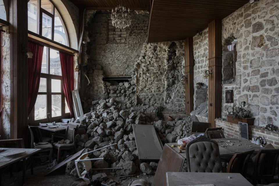 A view of the hall of a hotel destroyed during an earthquake in Antakya, southeastern Turkey, Monday, Feb. 13, 2023. Thousands left homeless by a massive earthquake that struck Turkey and Syria a week ago packed into crowded tents or lined up in the streets Monday for hot meals as the desperate search for survivors entered what was likely its last hours. (AP Photo/Bernat Armangue)