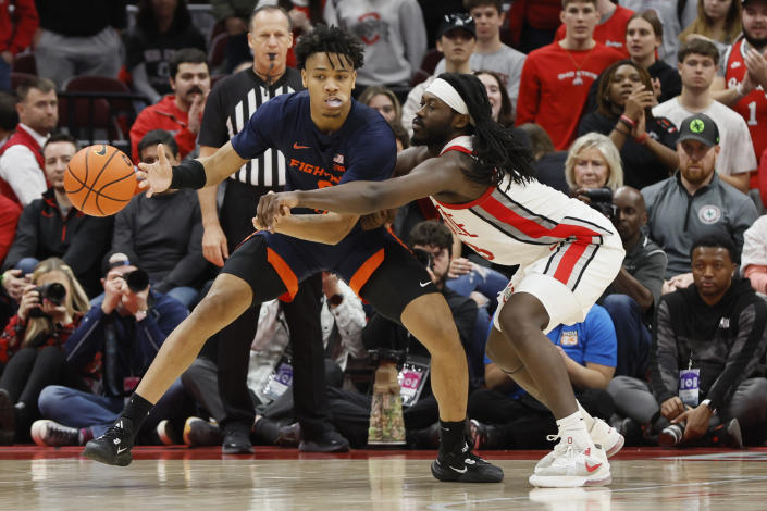 Ohio State's Isaac Likekele, right, knocks the ball away from Illinois' Terrence Shannon during the second half of an NCAA college basketball game Sunday, Feb. 26, 2023, in Columbus, Ohio. (AP Photo/Jay LaPrete)