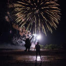 <p>A girl leaps into the air while watching a fireworks display, in celebration of the upcoming July 4 Independence Day, at Tod’s Point in Greenwich, Connecticut, July 1, 2017. (Photo: Adrees Latif/Reuters) </p>