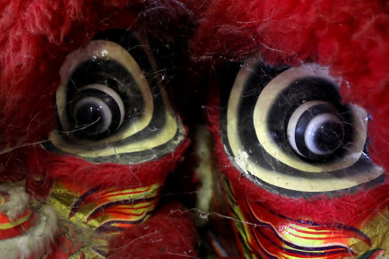 Spiderwebs and dust are seen between traditional Chinese lion dance masks at Kun Seng Keng Lion and Dragon Dance Association training centre, in Muar