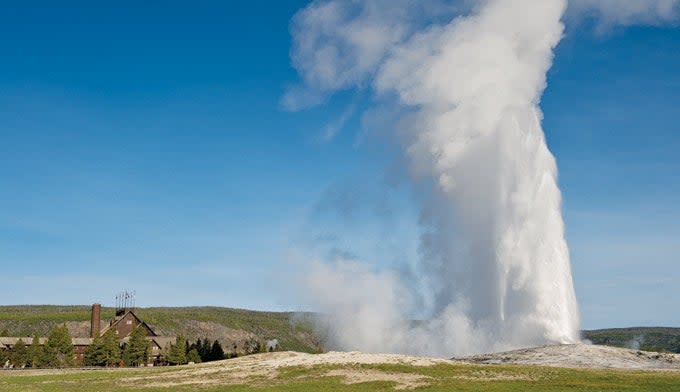 Old Faithful Geyser next to the Old Faithful Inn