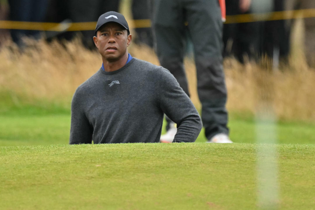 US golfer Tiger Woods looks on after playing from a green-side bunker on the 16th hole on the opening day of the 152nd British Open Golf Championship at Royal Troon on the south west coast of Scotland on July 18, 2024. (Photo by Glyn KIRK / AFP) / RESTRICTED TO EDITORIAL USE (Photo by GLYN KIRK/AFP via Getty Images)