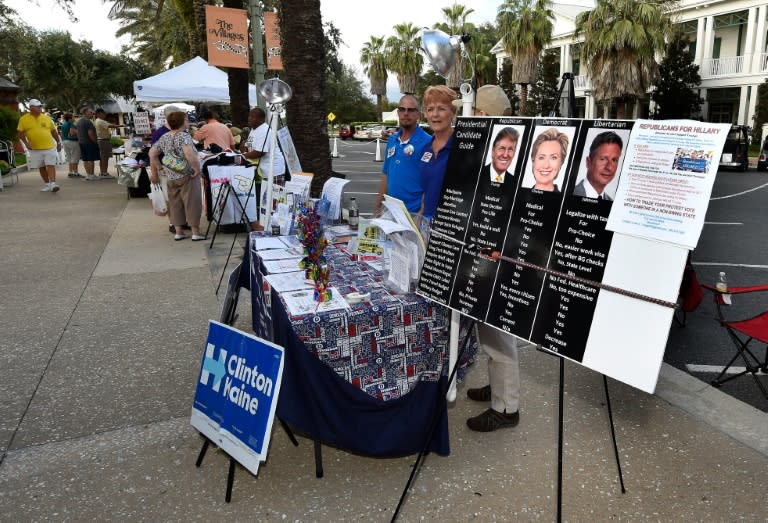 Democratic campaign volunteers work a booth in the square of The Villages retirement community outside Orlando, Florida