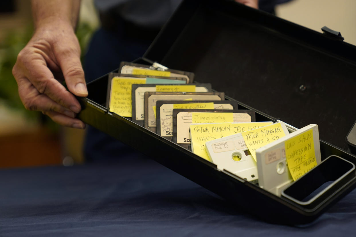 Peter Mangan shows a box containing tapes at the Lyndon B. Johnson's presidential library, Wednesday, Aug. 31, 2022, in Austin, Texas. The family of the late Associated Press reporter James W. Mangan has donated to the library cassette tapes containing interviews the reporter did that led to a 1977 story in which a Texas voting official detailed how three decades earlier, votes were falsified to give Johnson a slim victory in a U.S. Senate primary. (AP Photo/Eric Gay)