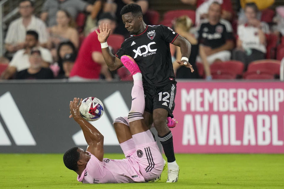 Inter Miami defender Israel Boatwright, bottom, becomes entangled with D.C. United forward Cristian Dájome (12) during the second half of an MLS soccer match, Saturday, July 8, 2023, in Washington. (AP Photo/Alex Brandon)