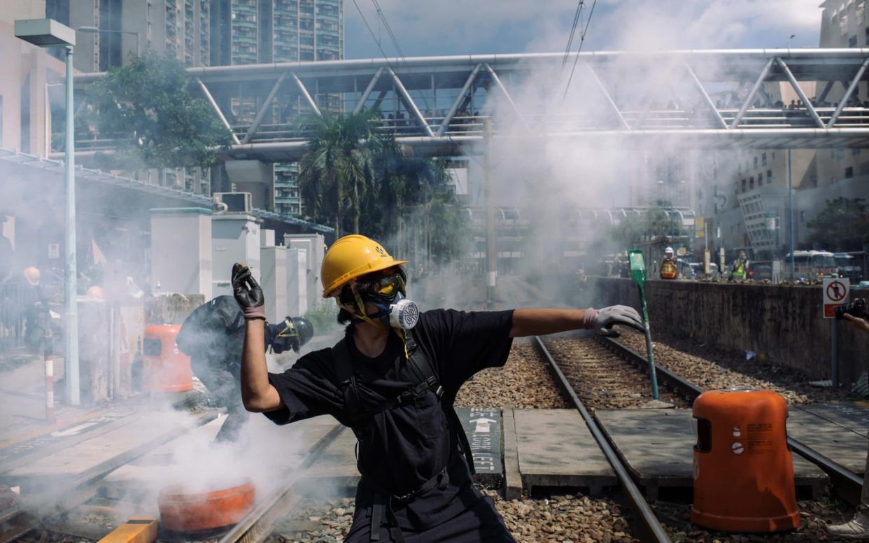 A protester throw a stone towards police outside Tin Shui Wai police station during a protest on August 05 - 2019 Getty Images