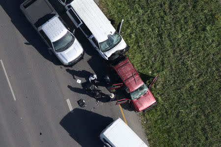 Law enforcement personnel investigate the scene where the Texas bombing suspect blew himself up on the side of a highway north of Austin in Round Rock, Texas, U.S., March 21, 2018. REUTERS/Loren Elliott