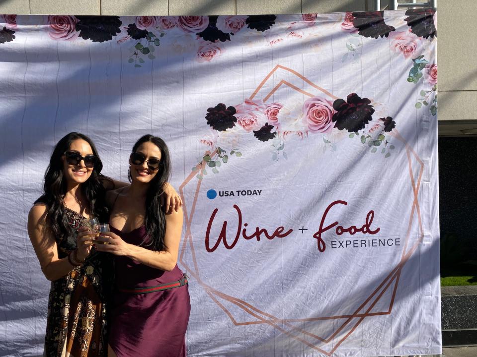 Wrestling-duo-turned-wine-aficionados Brie, left, and Nikki Bella pose together at the USA TODAY Wine and Food Experience after their meet-and-greet.