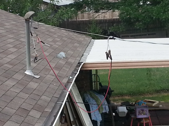 jumper cables hanging off the roof and attached to the power lines