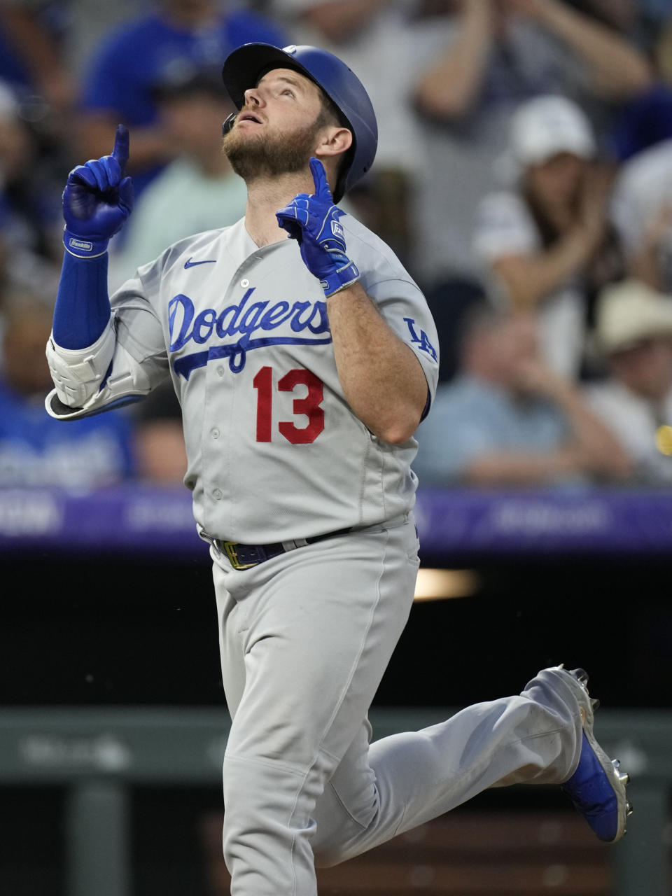 Los Angeles Dodgers' Max Muncy gestures as he crosses home plate after hitting a solo home run off Colorado Rockies relief pitcher Carlos Estevez during the eighth inning of a baseball game Saturday, July 17, 2021, in Denver. (AP Photo/David Zalubowski)