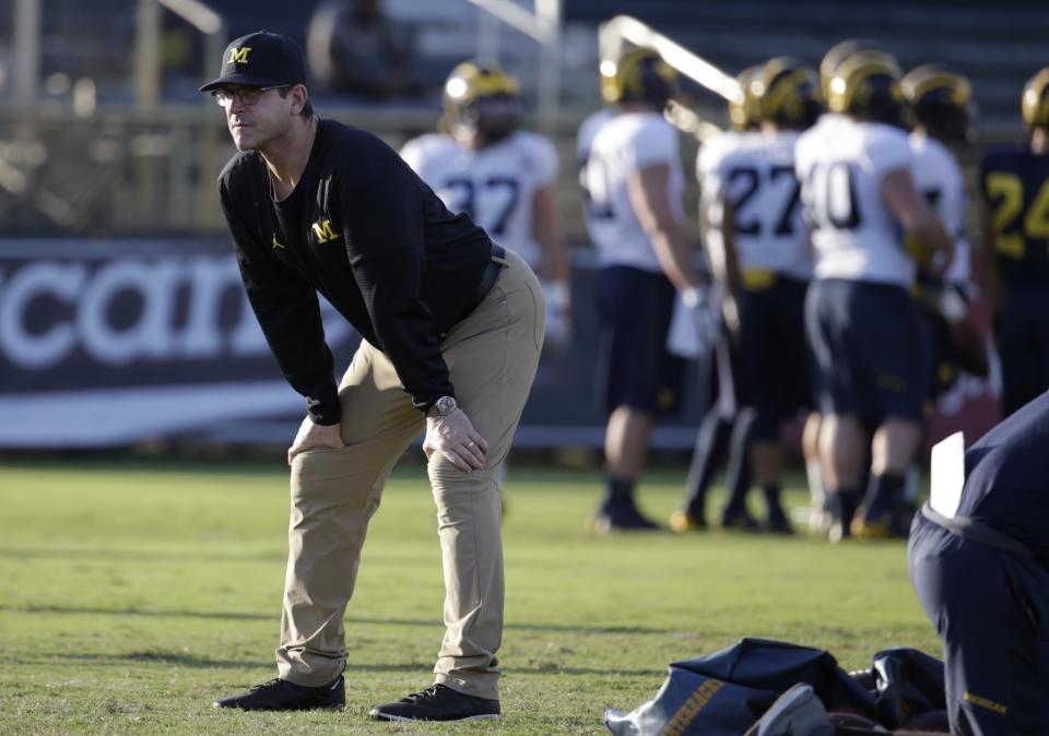 Jim Harbaugh and his khakis are going international. (AP Photo/Lynne Sladky)