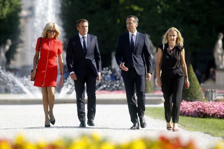 French President Emmanuel Macron and and his wife Brigitte Macron and Austrian Chancellor Christian Kern and his wife Eveline Steinberger-Kern pose for photographers in Salzburg, Austria, August 23, 2017. REUTERS/Heinz-Peter Bader