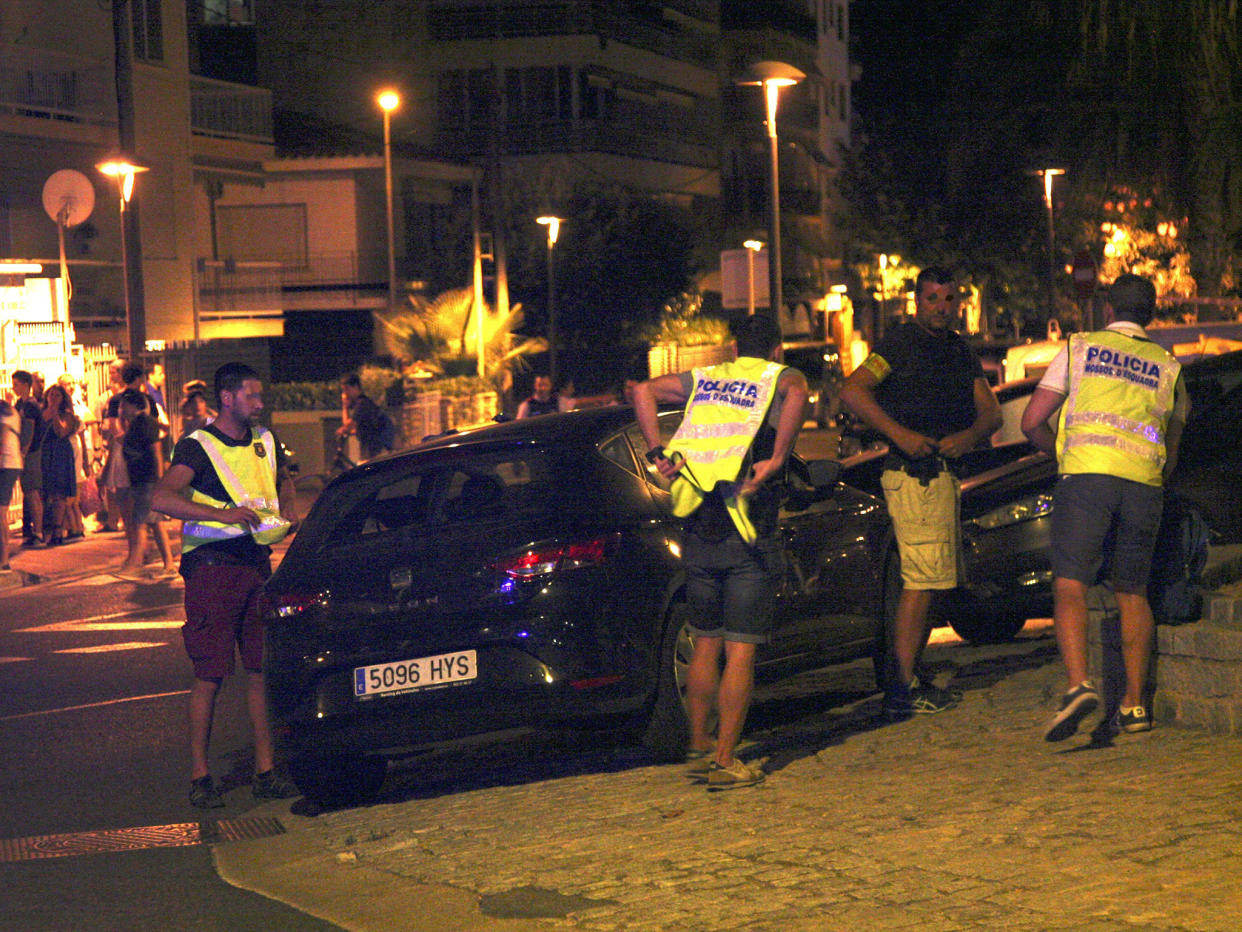 Spanish police inspect a car after suspected terrorists knocked down six civilians with their car at Paseo Maritimo in Cambrils: EPA