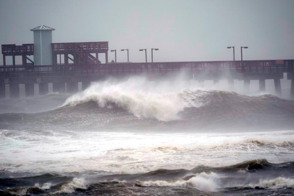 Waves crash near a pier on Tuesday at Gulf State Park in Gulf Shores, Alabama, ahead of the arrival of Hurricane Sally in the northern Gulf Coast.