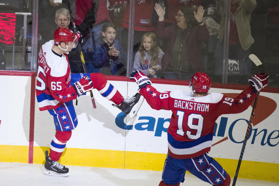 Washington Capitals left wing Andre Burakovsky (65), from Austria, celebrates his goal with center Nicklas Backstrom, from Sweden, during the third period of an NHL hockey game against the New Jersey Devils, Friday, Nov. 30, 2018, in Washington. The Capitals won 6-3. (AP Photo/Alex Brandon)
