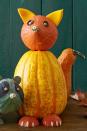 <p>Invite this happy friend into your house or onto your front porch. He'll greet party guests and trick-or-treaters with a welcoming smile.<strong><br></strong></p><p><strong>Make the Fox Pumpkin:</strong> Stand the variegated squash straight up. Break five skewers in half and stick them into the back of the squash where the tail should sit, leaving 2" exposed. Press the bell-shaped orange gourd into the skewers at the back of the squash to secure as the tail. (Tip: If the skewers sink into the squash too much as you attach the gourd, simply pinch each with two fingers to hold in place while the gourd slides onto the individual skewer.) <br></p><p>Break four skewers in half and press them into the top of the squash body, leaving 2" exposed. Position a small pumpkin so the stem is centered where the nose should sit and push down on the skewers to secure. With the tip of the craft knife, etch out a thin smile by scraping away just the top layer of rind. To create eye sockets, etch slightly deeper holes. Remove the caps of two large acorns. Flip each cap curved-side out and press into the sockets. Remove the caps of slightly smaller acorns. Apply a dot of hot glue to each acorn and affix to the eye socket caps as pupils. Using the craft knife, cut the small pumpkin into quarters (slice in half horizontally, then in half vertically), scraping away any excess flesh with the spoon. Rinse and clean a handful of seeds. Pat dry and set aside. Cut pointy ears from two of the pumpkin quarters and press into the pumpkin head with a skewer (break, as needed), allowing the fleshy side to face forward. Turn the remaining pumpkin quarters face down and use the hot glue to affix three pumpkin seeds to each to resemble claws. Secure to the body with skewers (break, as needed).</p>