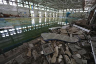 General view of the ruins of the sports complex of the National Technical University in Kharkiv, Ukraine, Friday, June 24, 2022, damaged during a night shelling. The building received significant damage. A fire broke out in one part but firefighters managed to put it out. (AP Photo/Andrii Marienko)