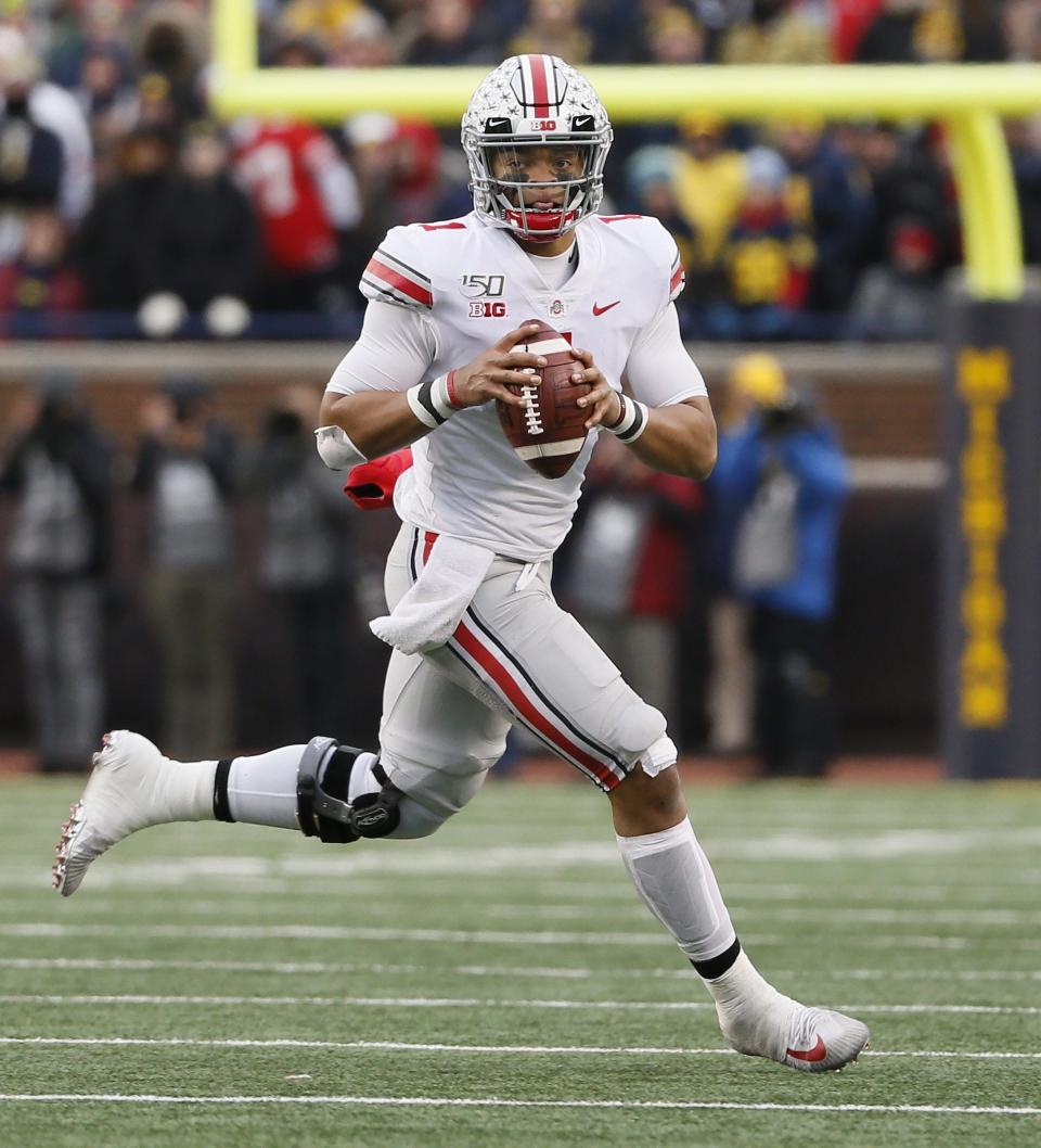 Ohio State Buckeyes quarterback Justin Fields (1) rolls out of the pocket during the fourth quarter of the NCAA football game against the Michigan Wolverines at Michigan Stadium in Ann Arbor, Mich. on Saturday, Nov. 30, 2019.  [Adam Cairns/Dispatch]