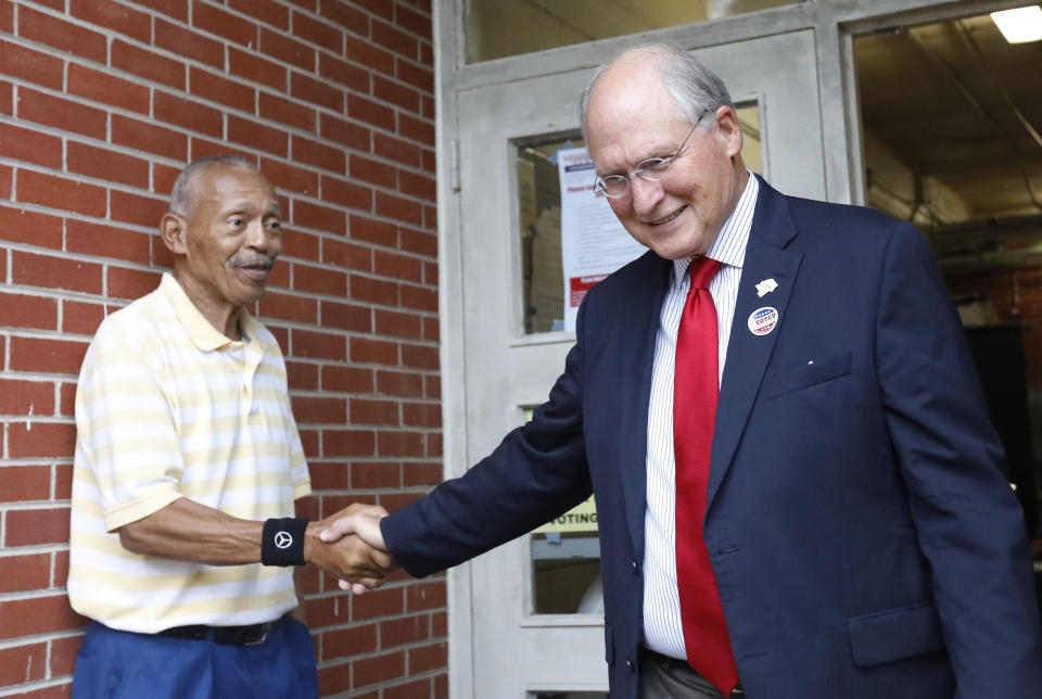 Former Mississippi Supreme Court Chief Justice Bill Waller Jr., right, shakes the hand of his Jackson, Miss., voting precinct bailiff Herbert Broome, Tuesday, Aug. 27, 2019, after voting at his Jackson, Miss., precinct. Waller is in a runoff race against Lt. Governor Tate Reeves for the GOP nomination for governor. (AP Photo/Rogelio V. Solis)