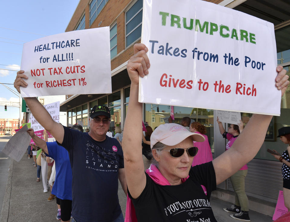 <p>Anne Kille of Flemingsburg, Ky., protests the arrival of Senate Majority Leader Mitch McConnell, R-Ky.,at the Lincoln Day Dinner, Friday, June 30, 2017, in Elizabethtown, Ky. (Photo: Timothy D. Easley/AP) </p>