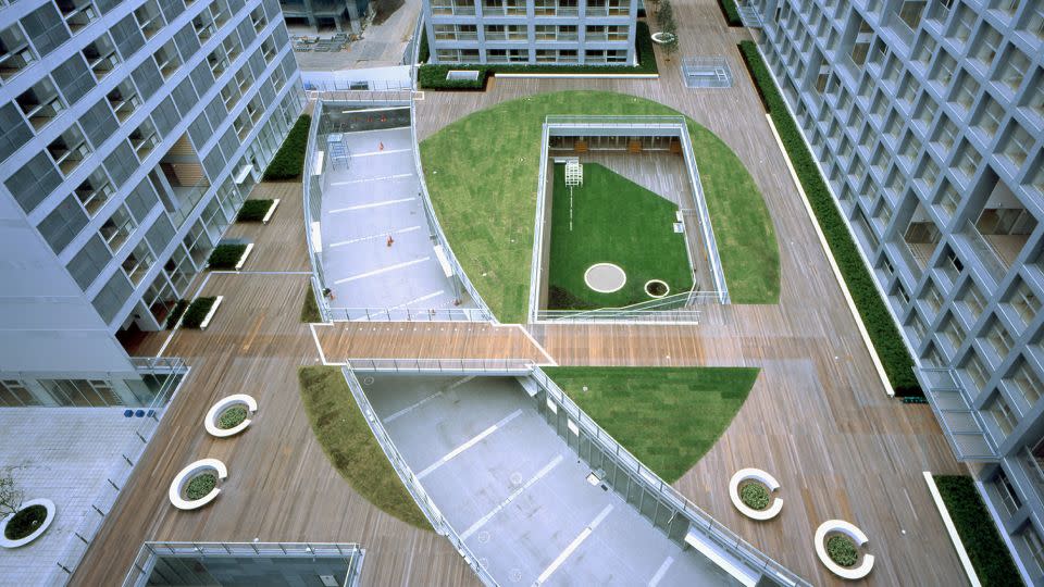 At Shinonome Canal Court in Tokyo, residential blocks are connected by a deck featuring terraces and public green spaces. - Courtesy Tomio Ohashi
