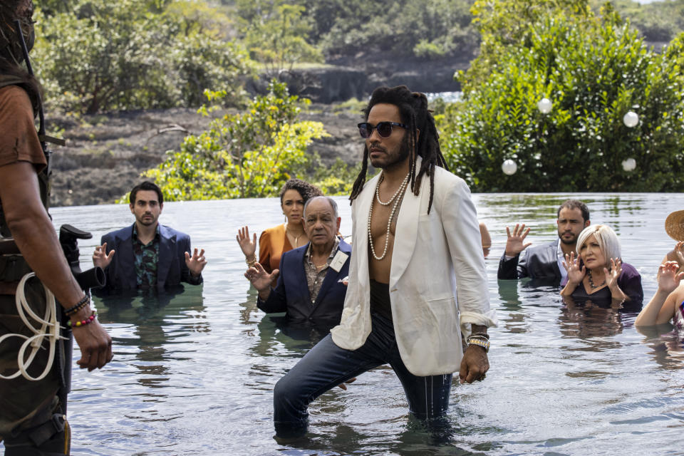 This image released by Lionsgate shows Lenny Kravitz, center, in a scene from "Shotgun Wedding." (Ana Carballosa/Lionsgate via AP)