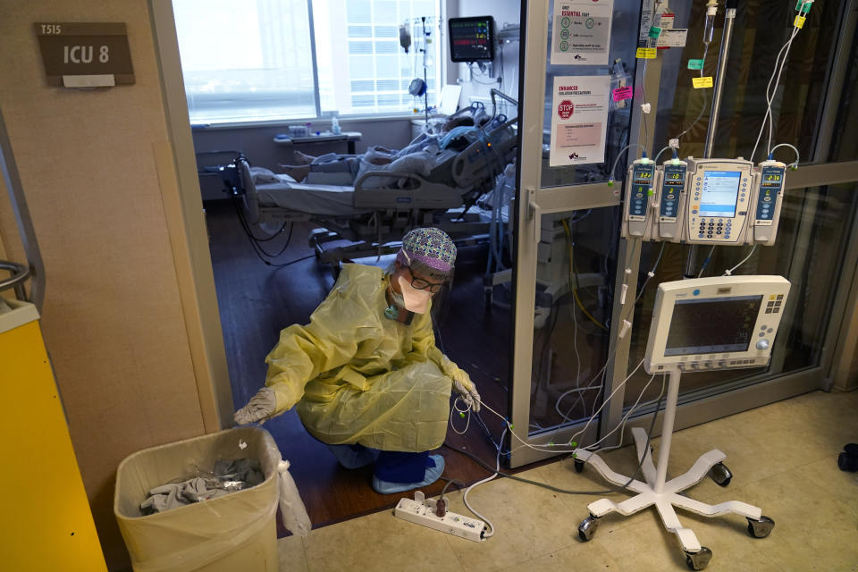 FILE - In this Aug. 17, 2021, file photo, an ICU nurse, moves electrical cords for medical machines, outside the room of a patient suffering from COVID-19, in an intensive care unit at the Willis-Knighton Medical Center in Shreveport, La. The COVID-19 pandemic has created a nurse staffing crisis that is forcing many U.S. hospitals to pay top dollar to get the help they need to handle the crush of patients this summer. (AP Photo/Gerald Herbert, File)