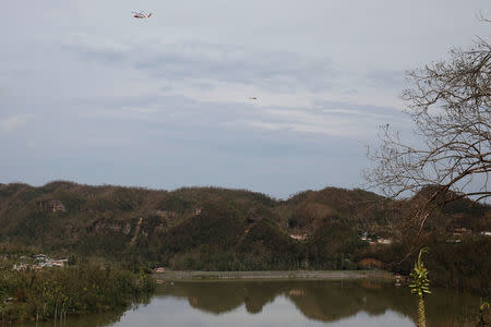 U.S. Coast Guard helicopters fly over the dam at the Guajataca lake. REUTERS/Carlos Garcia Rawlins