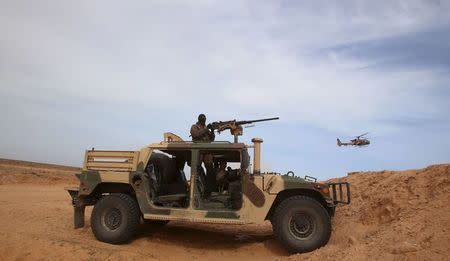 A Tunisian soldier holds his position during an exercise along the frontier with Libya in Sabkeht Alyun, Tunisia February 6, 2016. REUTERS/Zoubeir Souissi