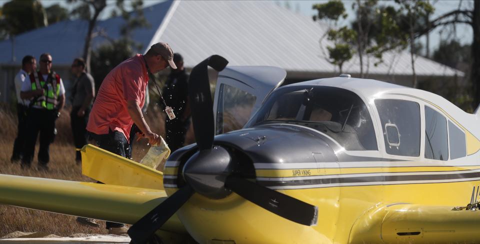 An investigator inspects a small plane which made an emergency landing on Vogiantzis Pkwy. in northeast Cape Coral Saturday, February 24, 2024. The pilot did not suffer any serious injuries.