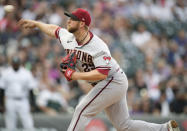 Arizona Diamondbacks starting pitcher Merrill Kelly works against the Colorado Rockies during the first inning of a baseball game Friday, July 1, 2022, in Denver. (AP Photo/David Zalubowski)