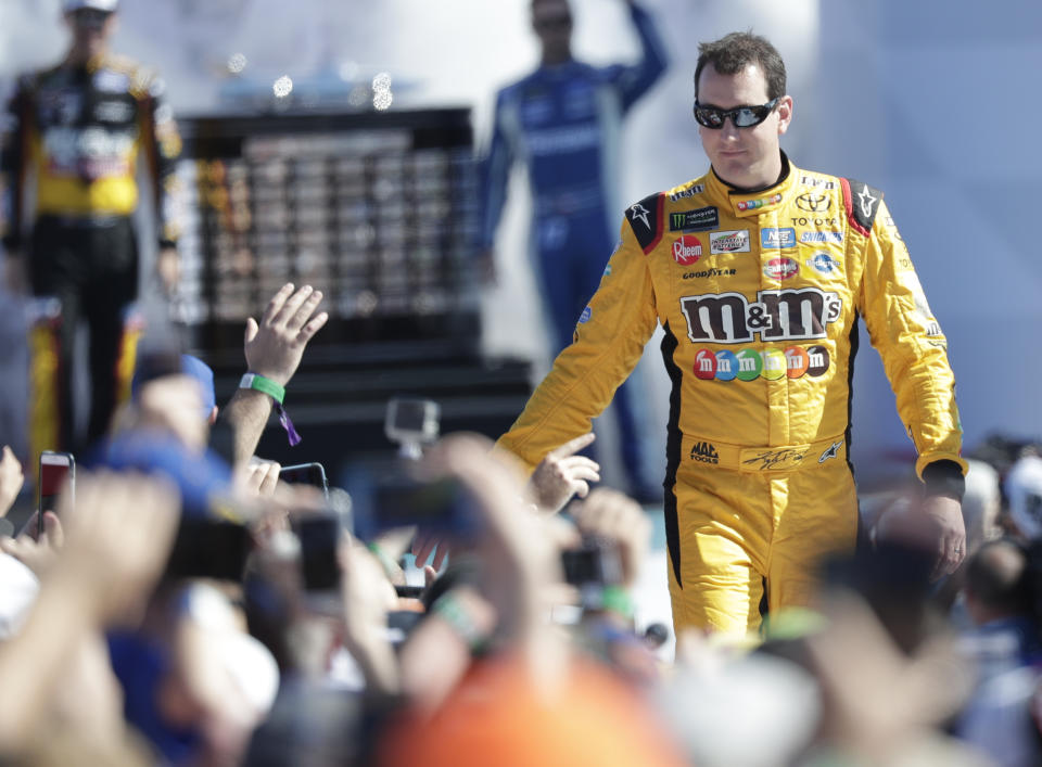 Kyle Busch greets fans as he is introduced before the NASCAR Daytona 500 Cup series auto race at Daytona International Speedway in Daytona Beach, Fla., Sunday, Feb. 18, 2018. (AP Photo/John Raoux)