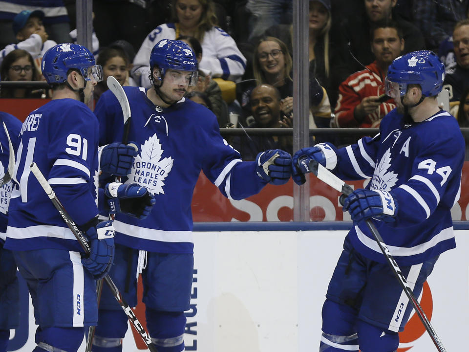 Sep 28, 2019; Toronto, Ontario, CAN; Toronto Maple Leafs defenseman Morgan Rielly (44) and forward John Tavares (91) congratulate forward Auston Matthews (34) on his goal against the Detroit Red Wings during the second period at Scotiabank Arena. Mandatory Credit: John E. Sokolowski-USA TODAY Sports