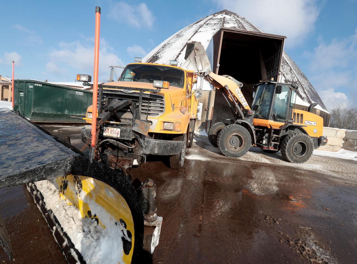 Bill Huff, a Perry Road Department maintenance specialist, loads road salt into a snowplow truck Tuesday morning at the township garage, 1500 Jackson Ave. SW.