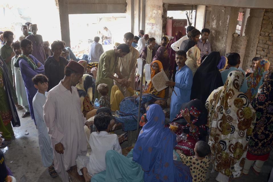 Sick women and children receive treatment at a temporary medical center setup in an abandoned building, in Jaffarabad, a flood-hit district of Baluchistan province, Pakistan, Thursday, Sept. 15, 2022. The devastating floods affected over 33 million people and displaced over half a million people who are still living in tents and make-shift homes. The water has destroyed 70% of wheat, cotton and other crops in Pakistan. (AP Photo/Zahid Hussain)