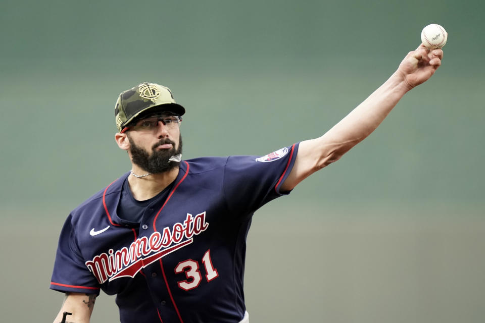 Minnesota Twins starting pitcher Devin Smeltzer throws during the first inning of a baseball game against the Kansas City Royals Friday, May 20, 2022, in Kansas City, Mo. (AP Photo/Charlie Riedel)