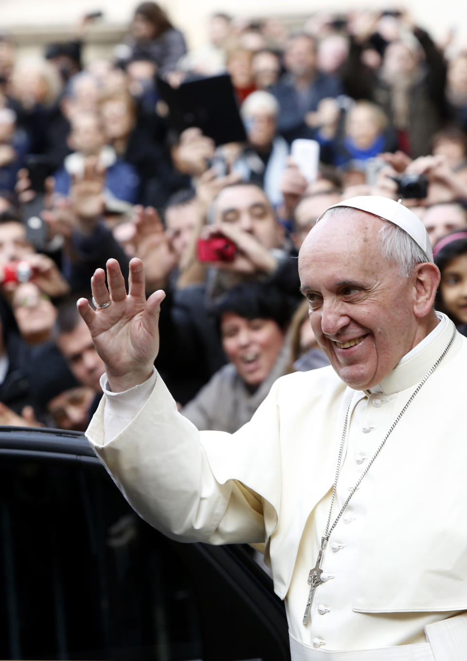 Pope Francis waves as he leaves Rome's Jesus' Church after celebrating a mass with the Jesuits, on the occasion of the order's titular feast, Friday, Jan. 3, 2014. (AP Photo/Riccardo De Luca)