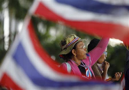 An anti-government protester blows her whistle during a rally outside the office of Election Commission in Bangkok May 15, 2014. REUTERS/Chaiwat Subprasom