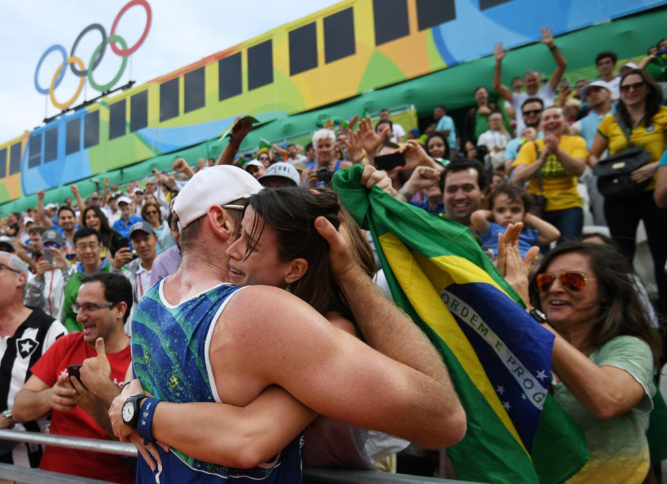 <p>Alison Cerutti of Brazil celebrates in the crowd after match point in the Men’s Beach Volleyball Quarterfinal match between the United States and Brazil on Day 10 of the Rio 2016 Olympic Games at the Beach Volleyball Arena on August 15, 2016 in Rio de Janeiro, Brazil. (Photo by Matthias Hangst/Getty Images) </p>