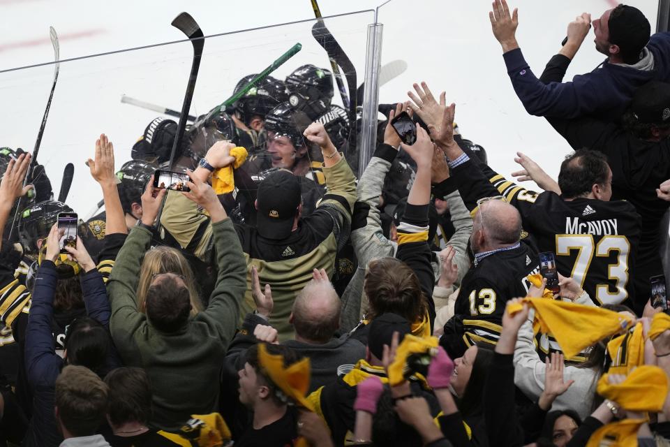 Fans celebrate after the Boston Bruins defeated the Toronto Maple Leafs in overtime during Game 7 of an NHL hockey Stanley Cup first-round playoff series, Saturday, May 4, 2024, in Boston. (AP Photo/Michael Dwyer)