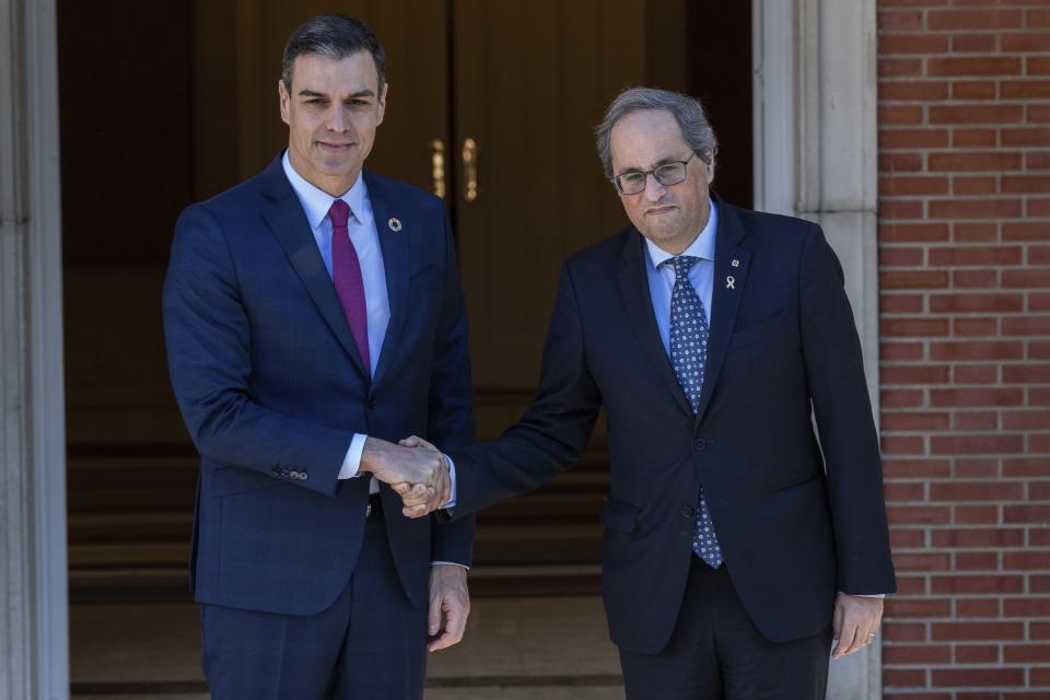 Spanish Prime Minister Pedro Sanchez, left, shakes hands with Catalan regional President Quim Torra at the Moncloa palace in Madrid, Spain, Wednesday, Feb. 26, 2020. Spain's prime minister and the leader of Catalonia are opening formal talks Wednesday in hopes of resolving the festering political crisis provoked by the region's separatist movement. (AP Photo/Bernat Armangue)