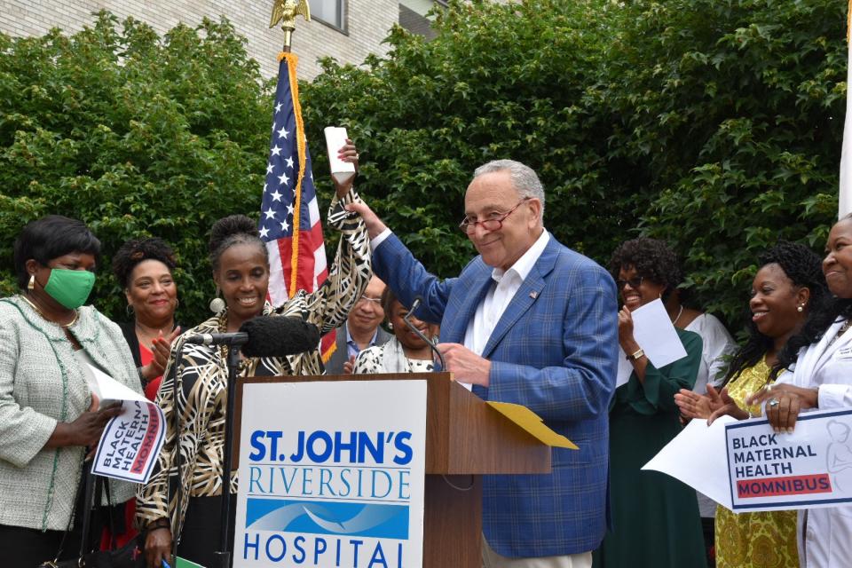 Cheryl Brannan, left, the founder of the nonprofit Sister to Sister International, embraces U.S. Senate Majority Leader Charles E. Schumer, at St. John's Riverside Hospital in Yonkers in July 2022.