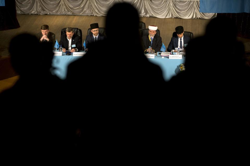 Mufti of Crimean Muslims Emirali Ablayev, second from right, the Crimean Tatar Qurultay, attends a religious congress, in Bakhchysarai, Crimea, Saturday, March 29, 2014. The Crimean Tatar Qurultay, a religious congress will determine whether the Tatars will accept Russian citizenship and the political system that comes with it, or remain Ukrainian citizens on Russian soil. (AP Photo/Pavel Golovkin)