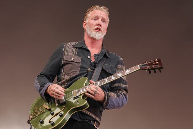 <p>Getty</p> Josh Homme performs with Queens of the Stone Age