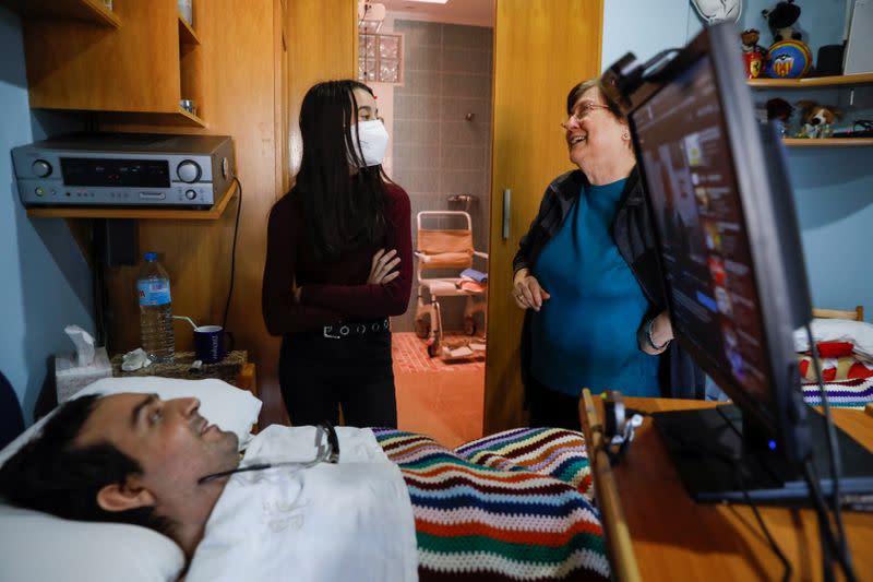 Rafael Botella, 35, tetraplegic since he was 19 after a car crash where his girlfriend died, chats with his mother Maria Luisa, 73, and his goddaugther Aitana, 12, at his home in Simat de la Valldigna